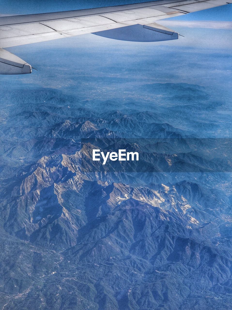 AERIAL VIEW OF AIRPLANE FLYING OVER LANDSCAPE