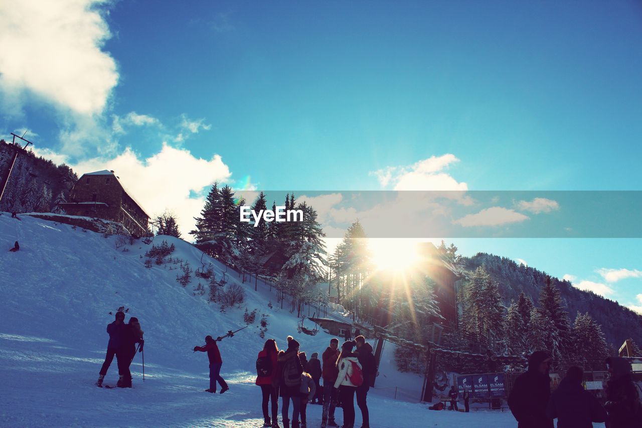 PEOPLE ON SNOW COVERED LANDSCAPE