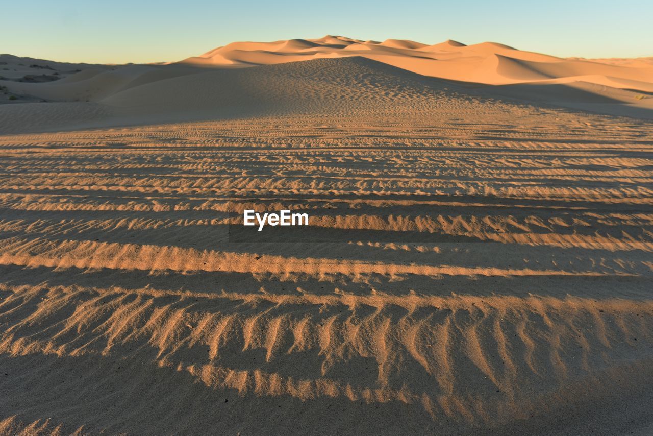 Scenic view of desert against sky during sunset