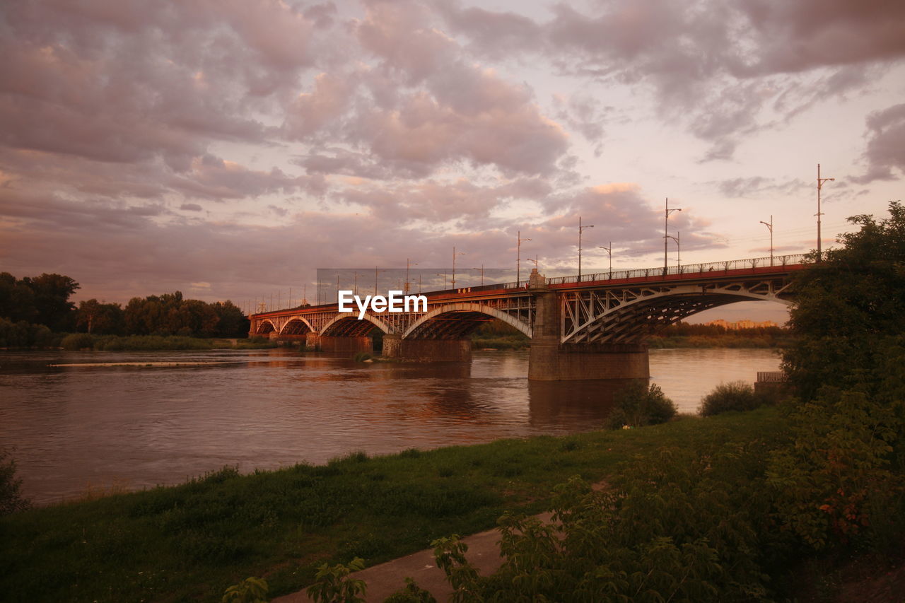 Bridge over vistula river against cloudy sky