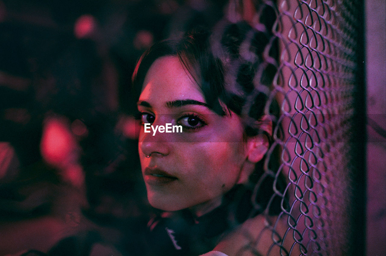 Close-up portrait of young woman at night