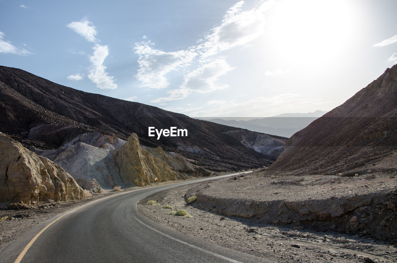 Road amidst mountains against sky