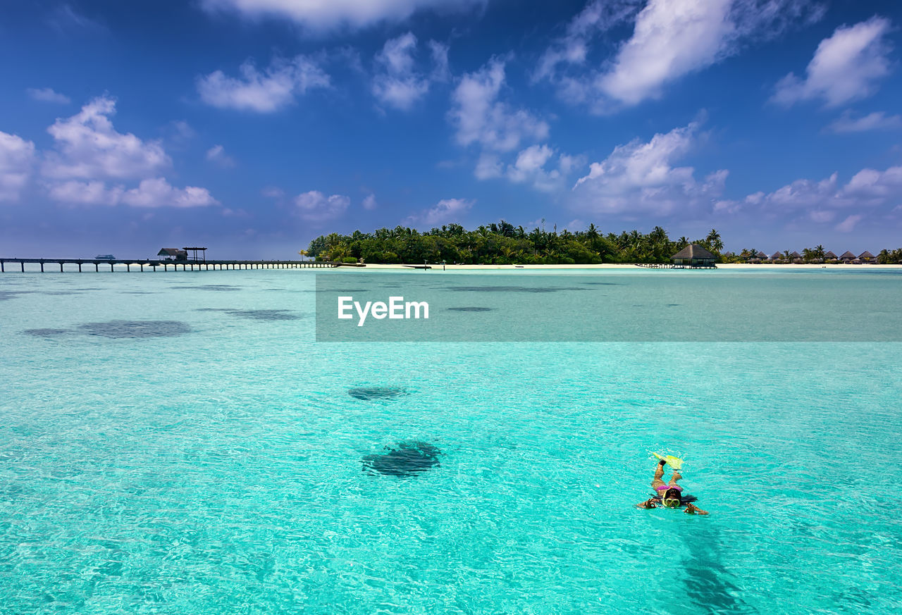 High angle view of woman swimming in sea