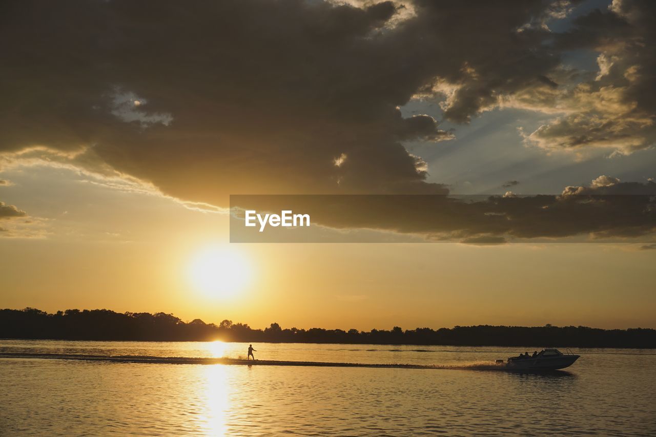 SCENIC VIEW OF SUNSET OVER SEA