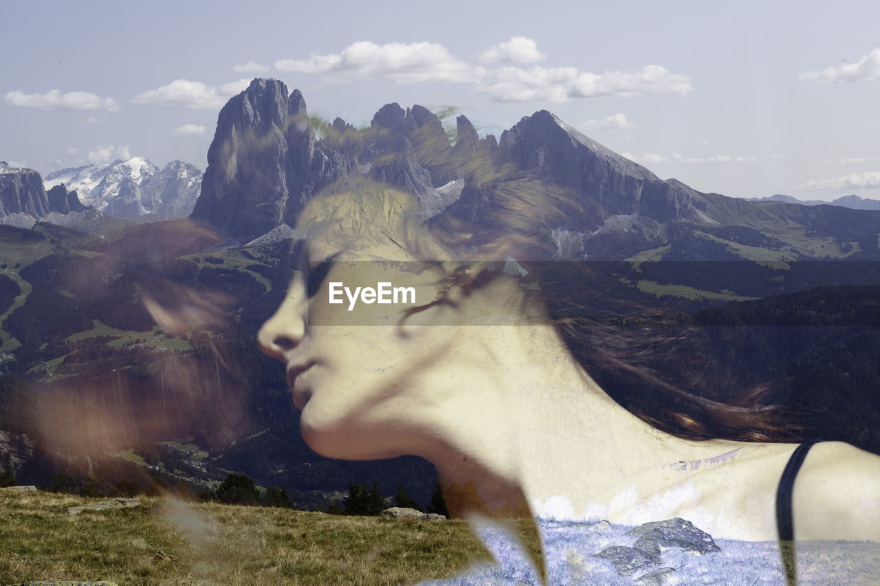 Double exposure of woman and mountains