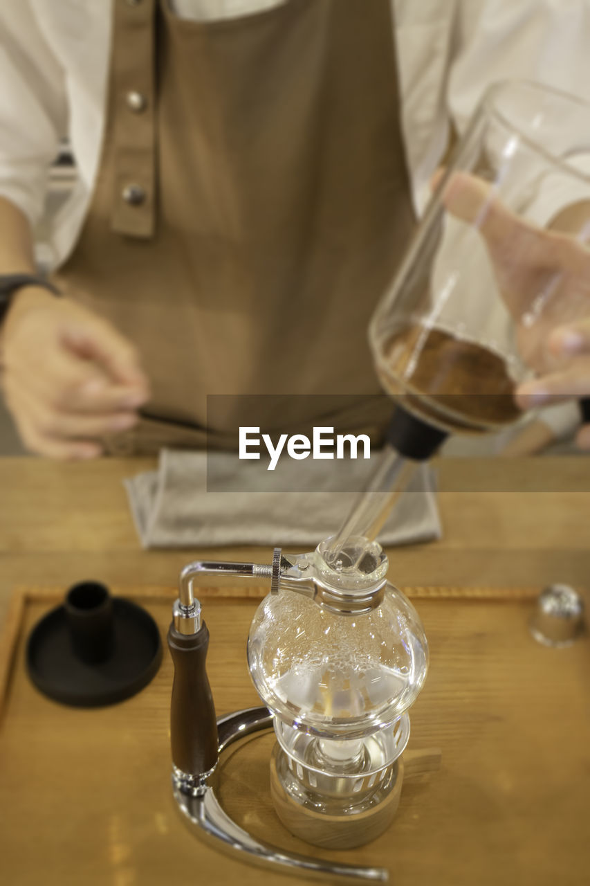 midsection of lawyer holding wineglass