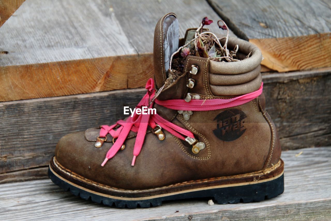 footwear, shoe, sneakers, brown, wood, spring, leather, boot, no people, shoelace, outdoor shoe, still life, close-up, red