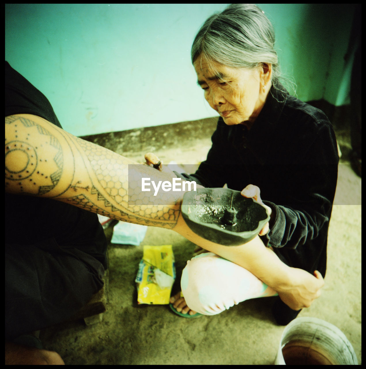 Apo Whang Od - the oldest tattoo artist in the world. The hundred year old still works everyday in her village Buscalan in the Kalinga mountains of Northern Luzon in the Philippines Adventure Age Analogue Photography Apo Whang Od Buscalan Philippines Film Photography Grace HERO Kalinga Mountains Northern Luzon Outdoors Pain Philippines Shadow Tattoo Tattoo Artist The Photojournalist - 2017 EyeEm Awards The Portraitist - 2017 EyeEm Awards Tradition Traditional Tattoo Traditional Tattoos Travel Wisdom Xpro