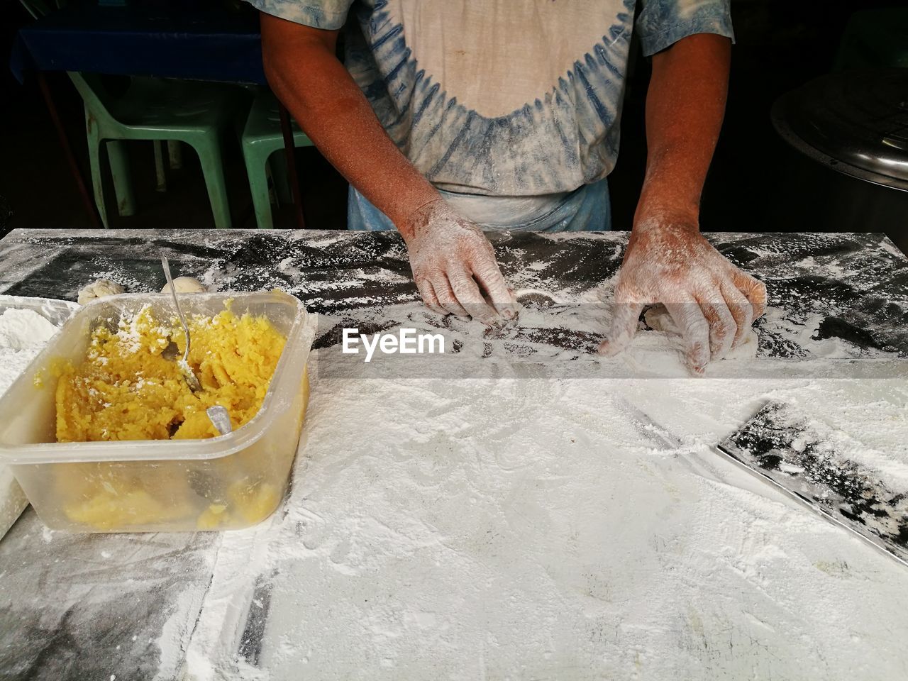 Midsection of woman preparing food in kitchen