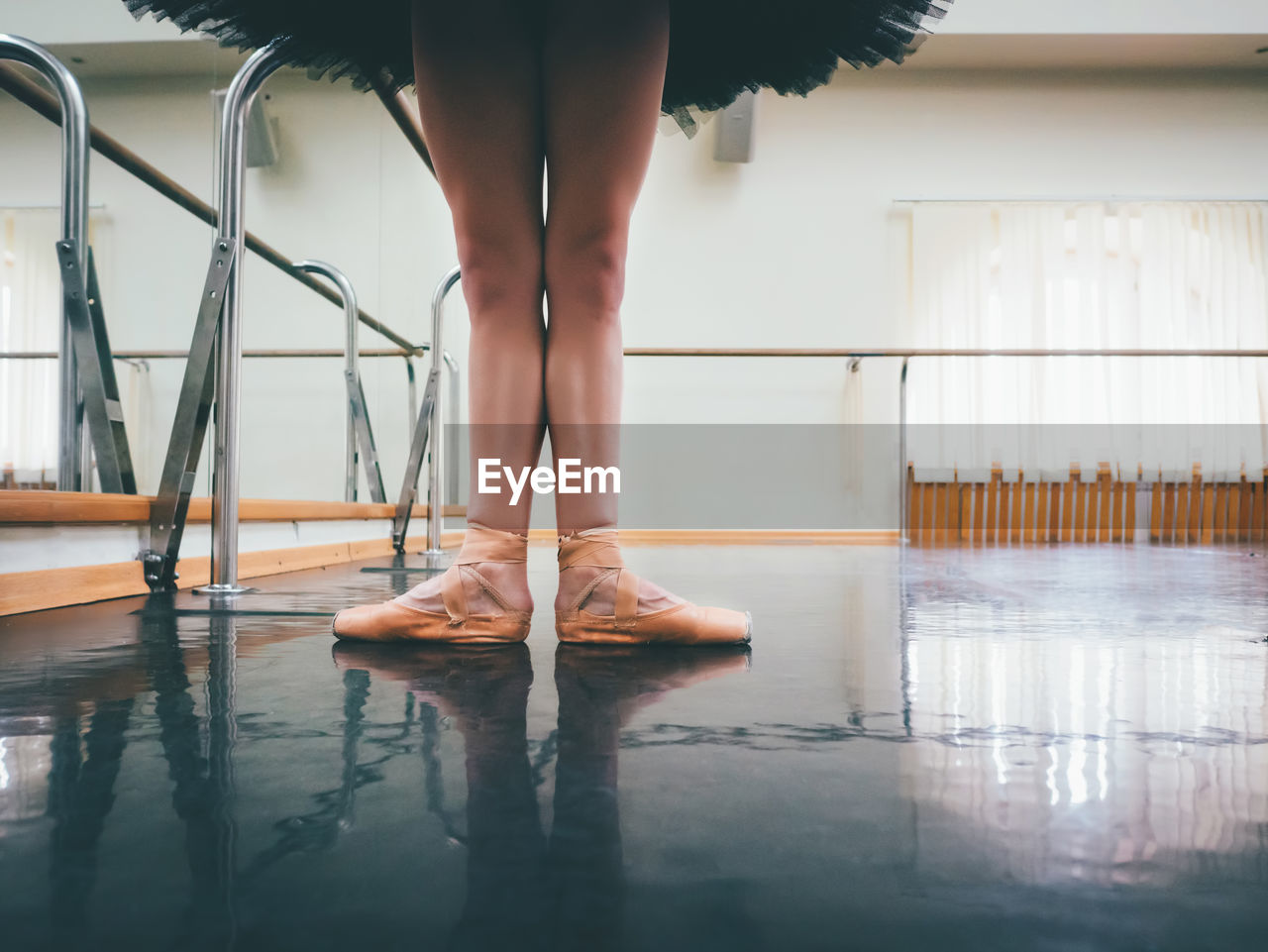 Low section of ballet dancer standing on floor