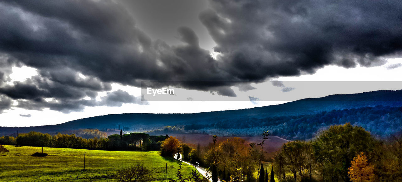 SCENIC VIEW OF MOUNTAINS AGAINST CLOUDY SKY