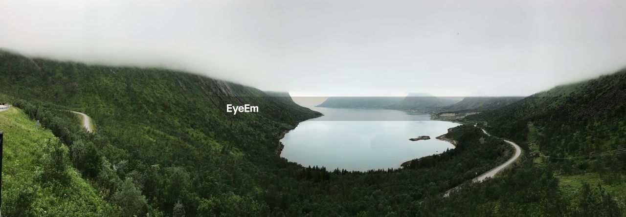 Scenic view of sea and mountains against sky