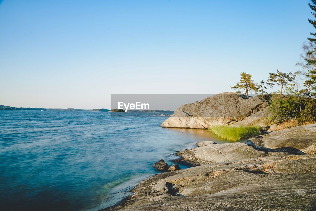 Scenic view of sea against clear blue sky