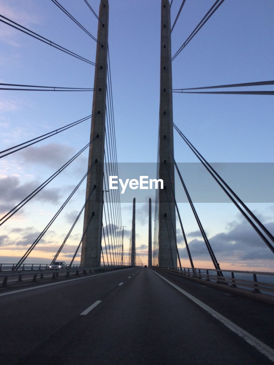 Cable-stayed bridge against sky during sunset