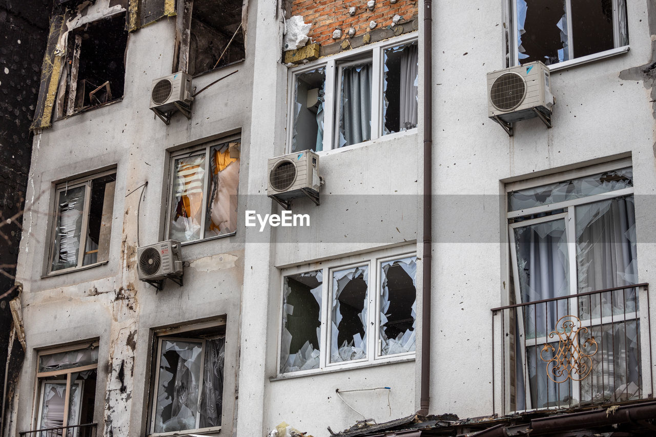 Destroyed buildings on the streets of irpen. broken, shelled windows.