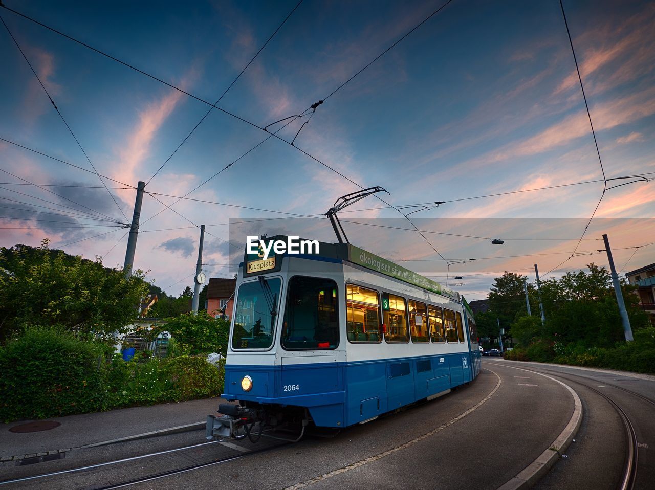 Cable car on street against sky during sunset