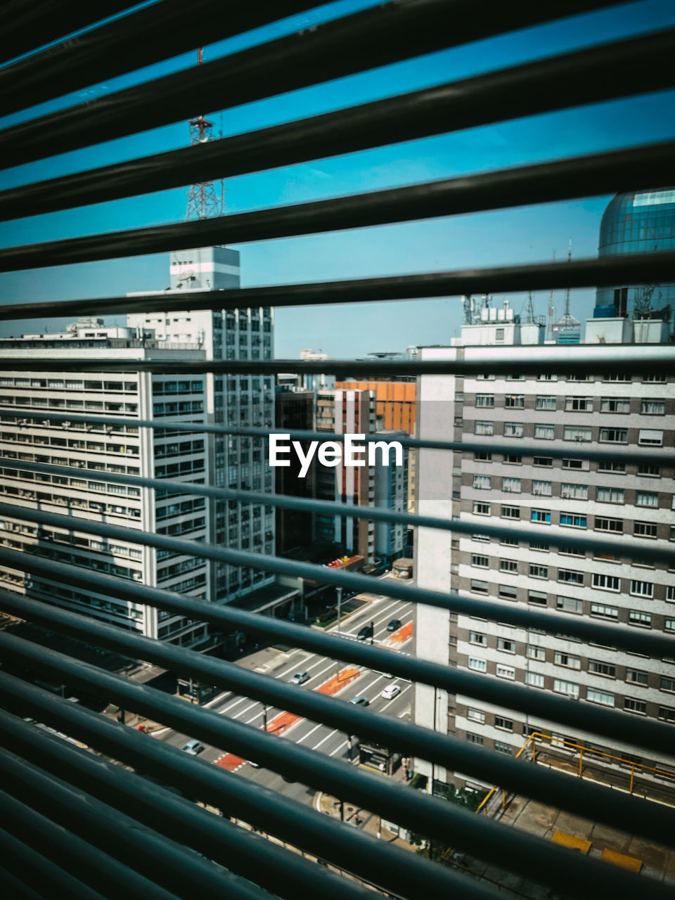 Modern buildings against sky seen through glass window