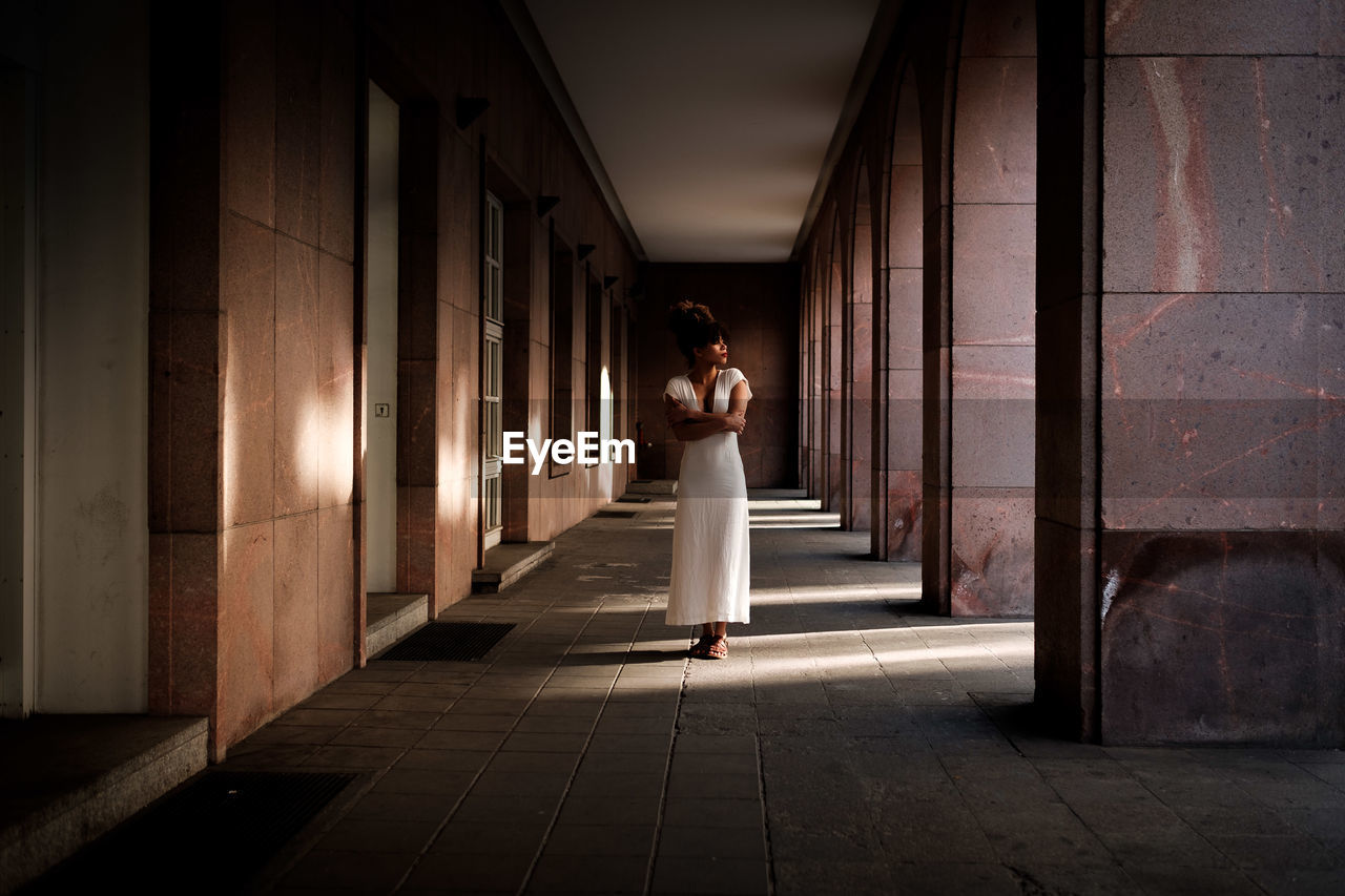Teenage girl standing in corridor of building