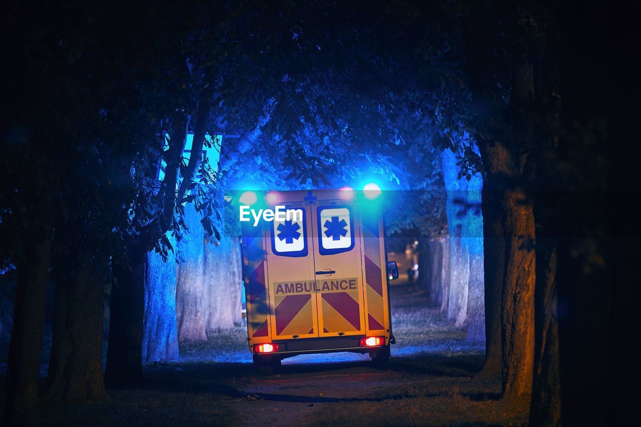 Rear view of ambulance on street at night