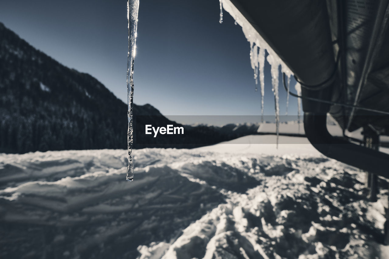 Close-up of stalactites on mountain view covered by the snow.