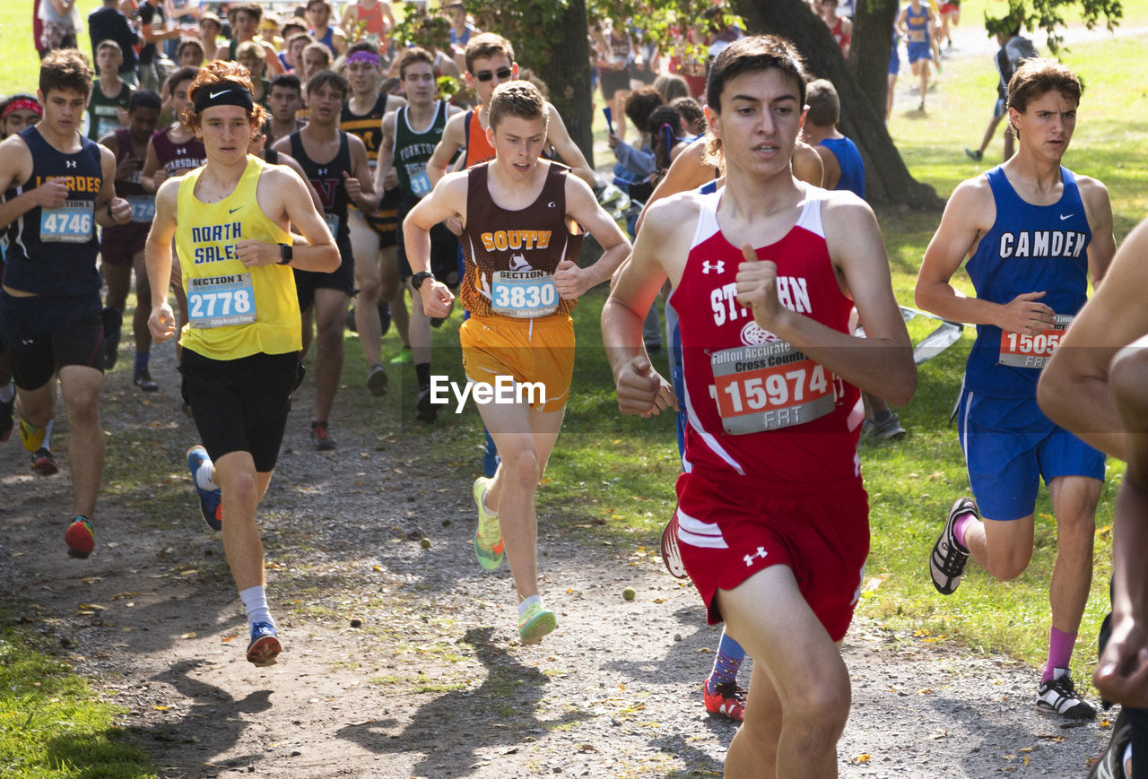 GROUP OF PEOPLE RUNNING AT OUTDOOR SQUARE