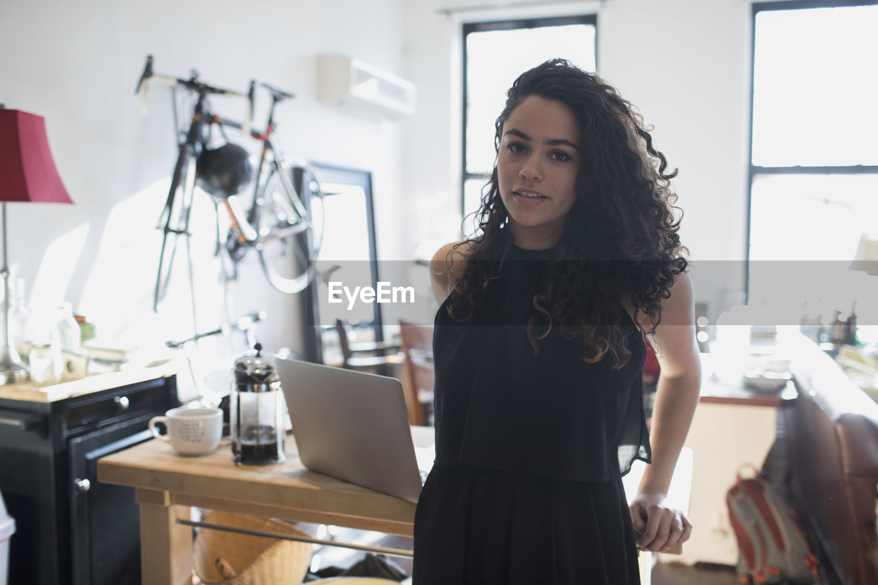 A young woman leaning on a desk