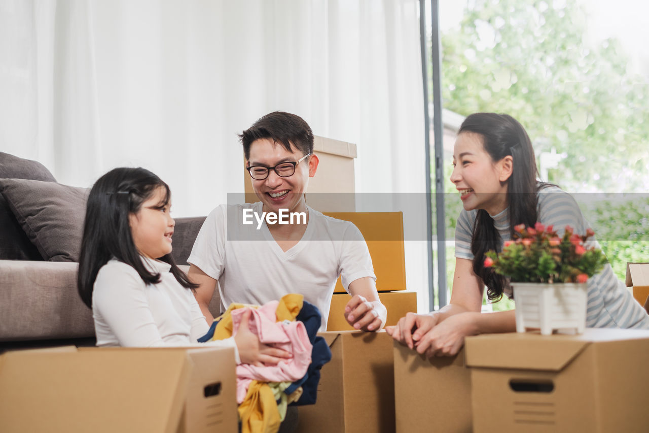 Family unpacking boxes at home