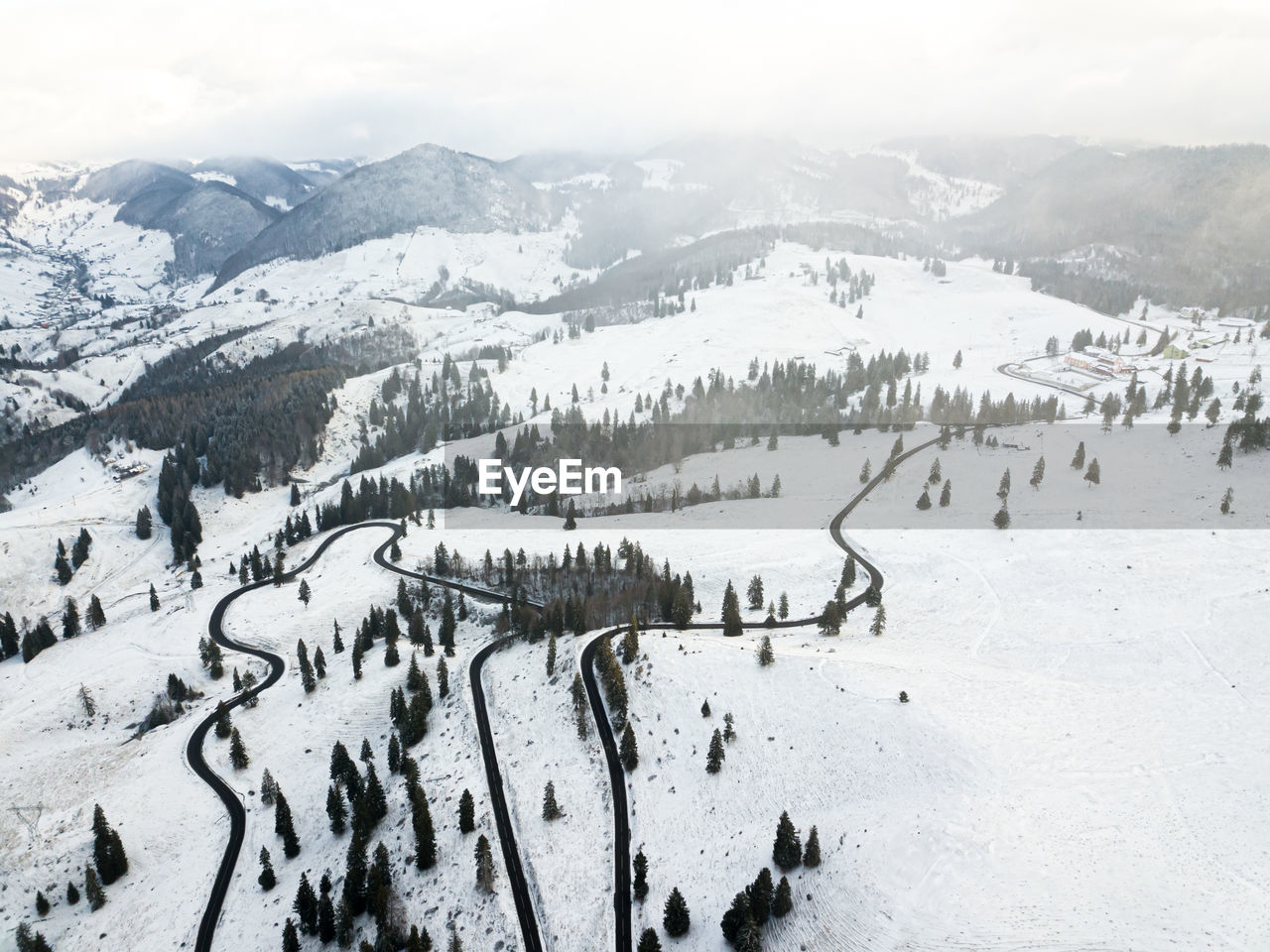 Long winding rural road with snow