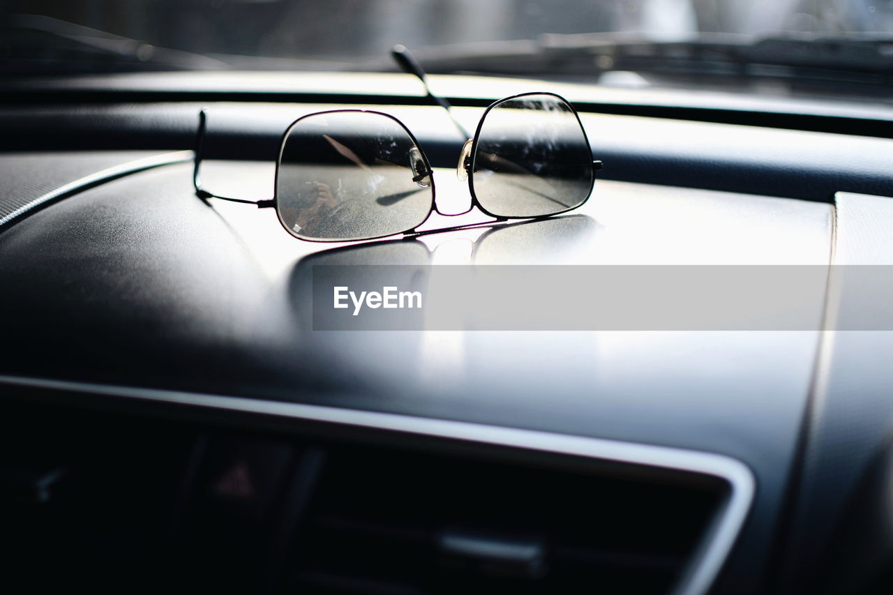 Close-up of sunglasses on dashboard