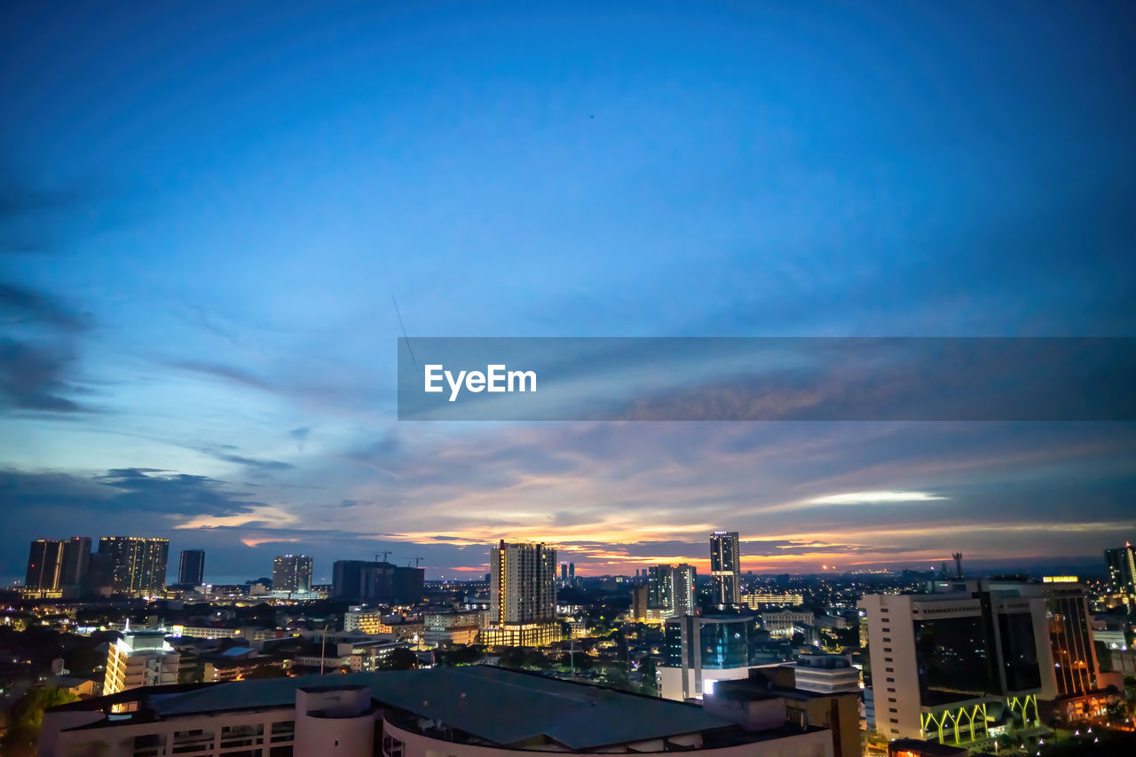 Blurry panoramic view of city skyline, traffic and light during sunset. colourful city lights.