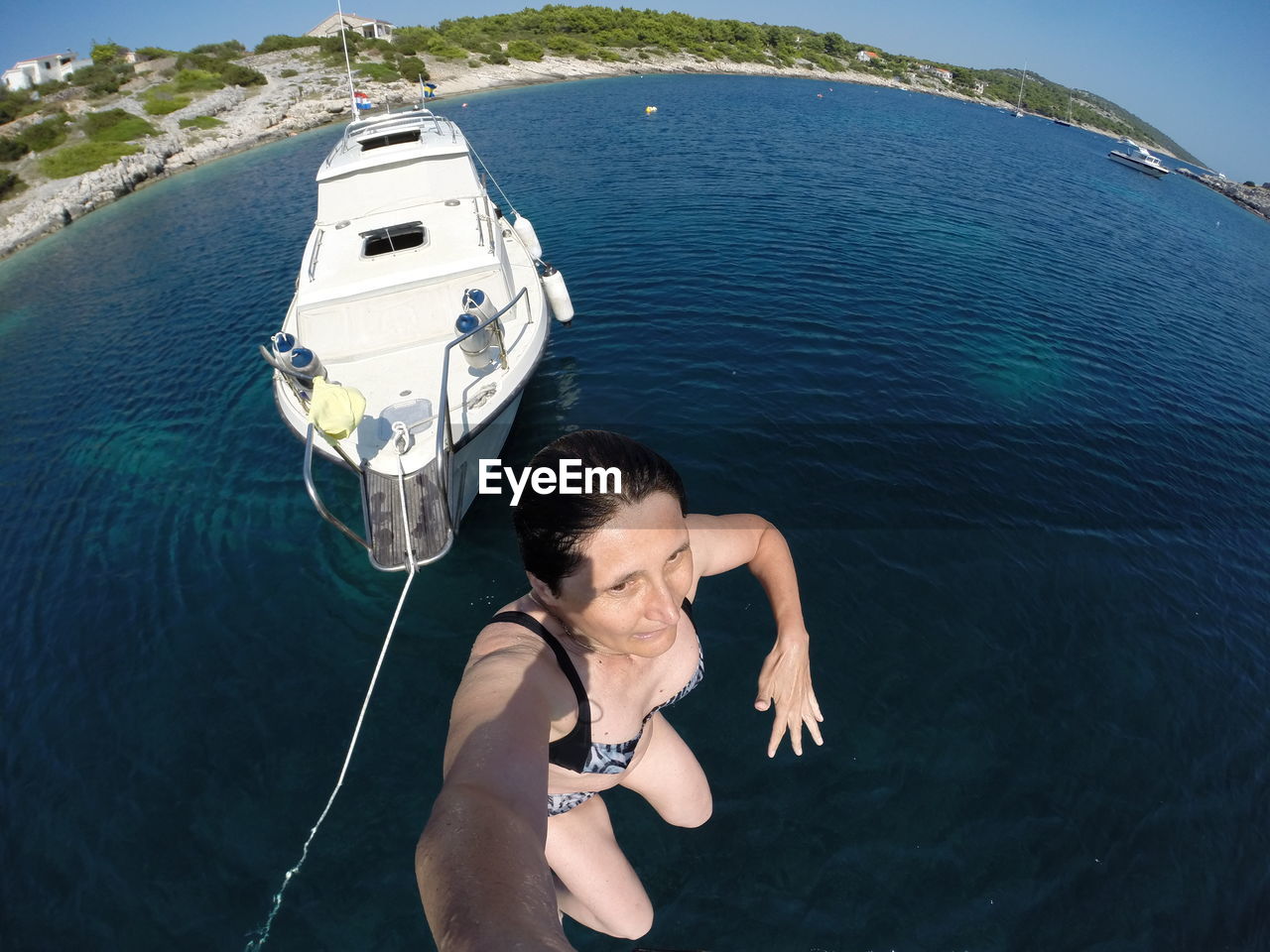 High angle view of woman diving in sea against boat