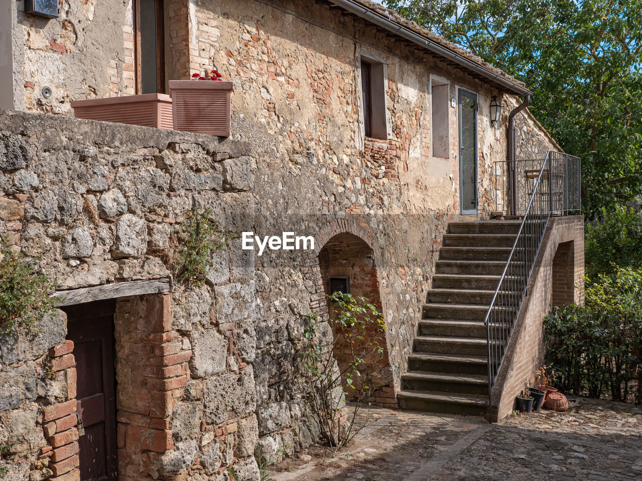 Ancient farmhouse and rural dwelling with outdoor stairs in monteriggioni, siena - italy.