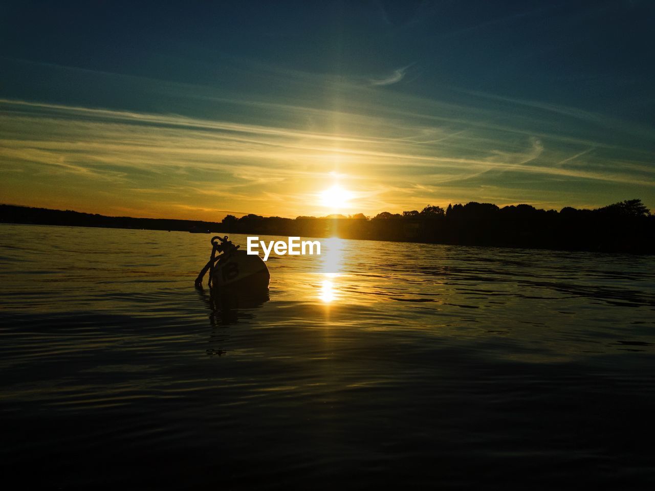 SILHOUETTE MAN IN SEA DURING SUNSET