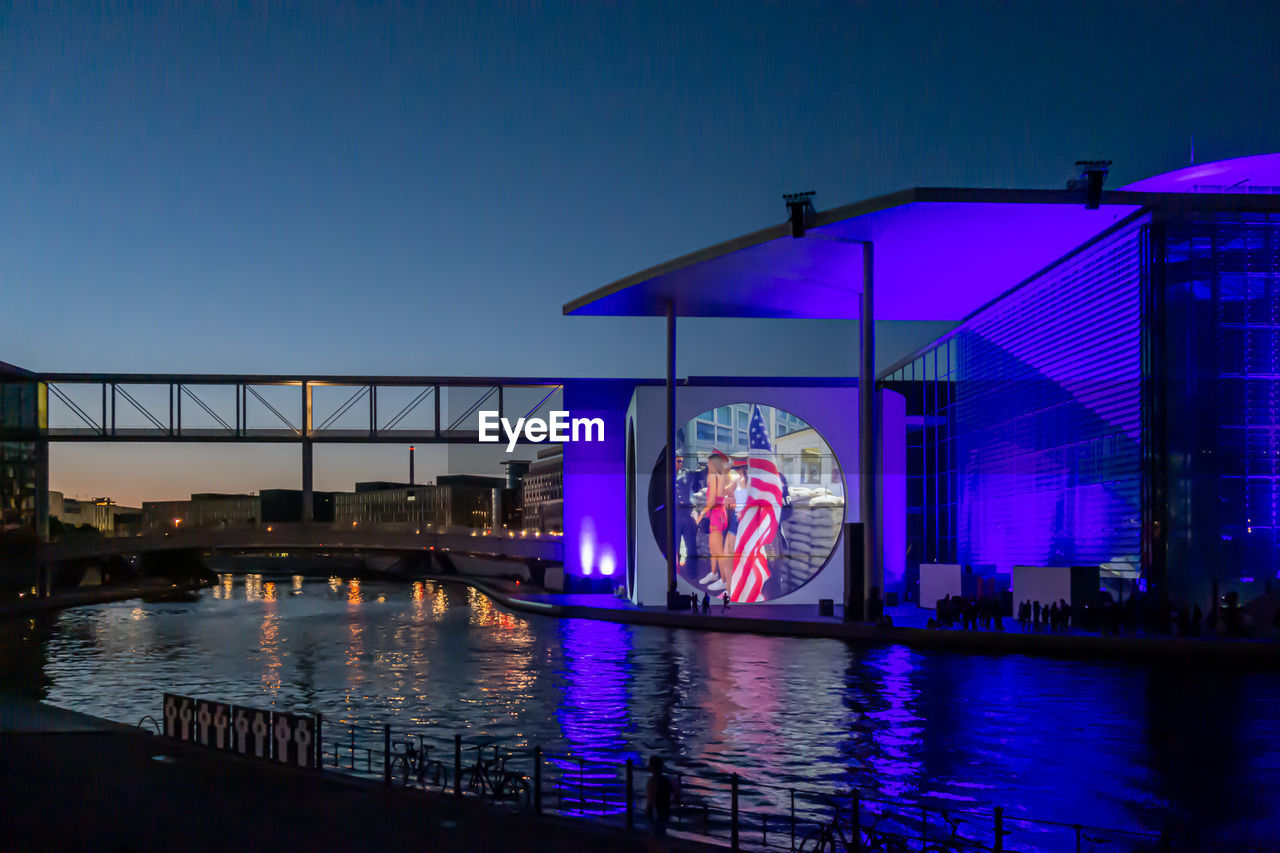 architecture, night, water, built structure, reflection, illuminated, building exterior, city, travel destinations, evening, sky, blue, nature, stage, no people, arts culture and entertainment, dusk, nightlife, waterfront, travel, light, building, outdoors, bridge, river, multi colored