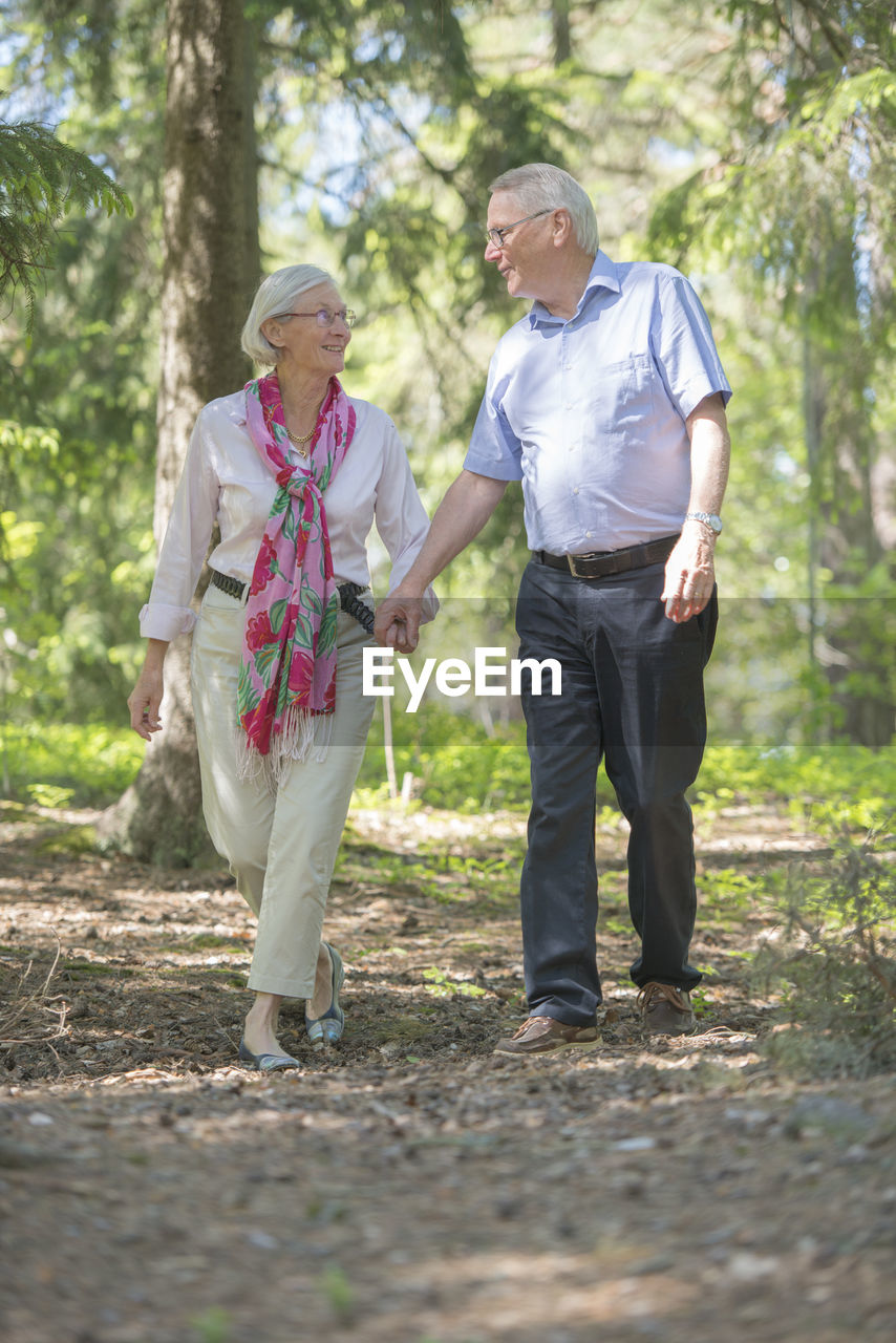 Senior couple walking in forest