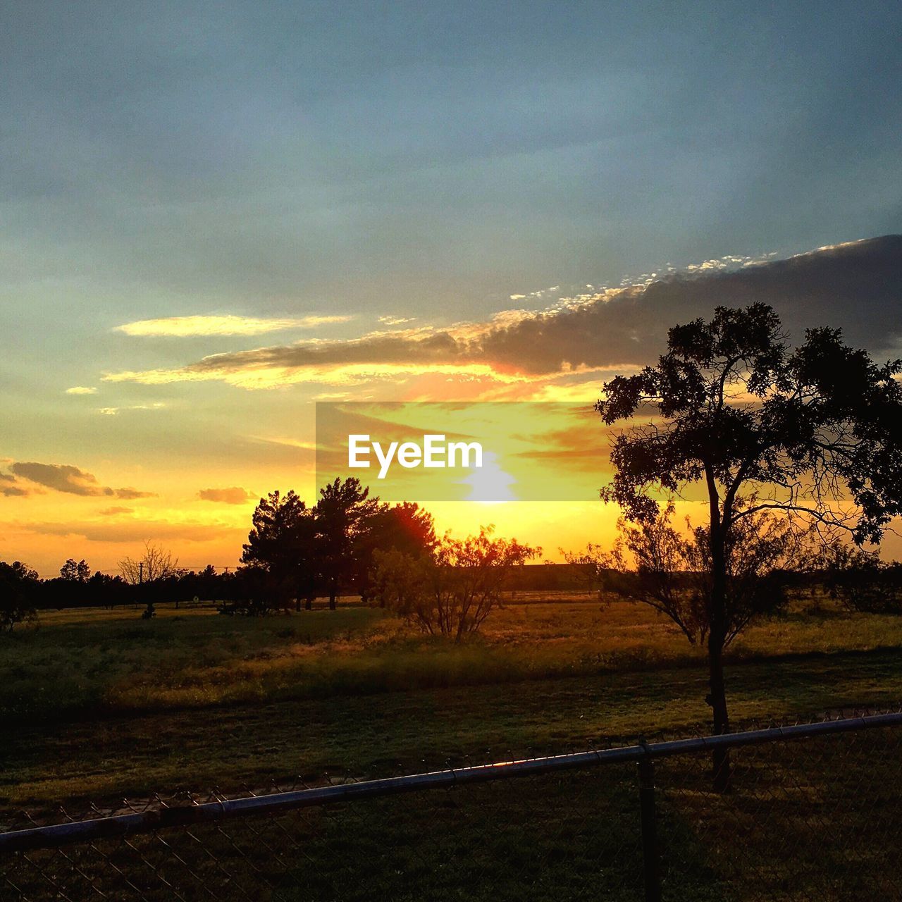 Scenic view of landscape against sky at sunset