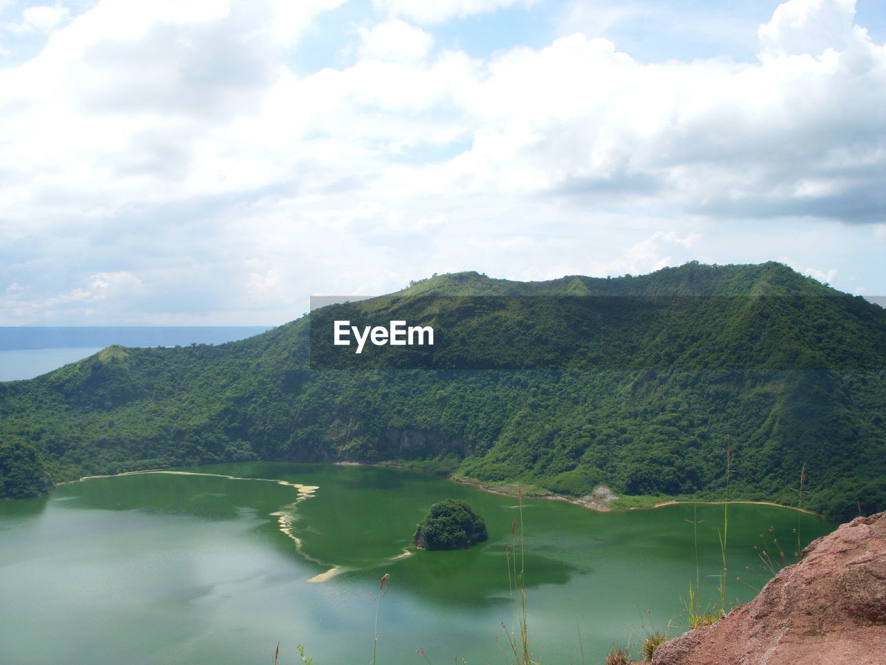 Scenic view of lake and mountains against sky