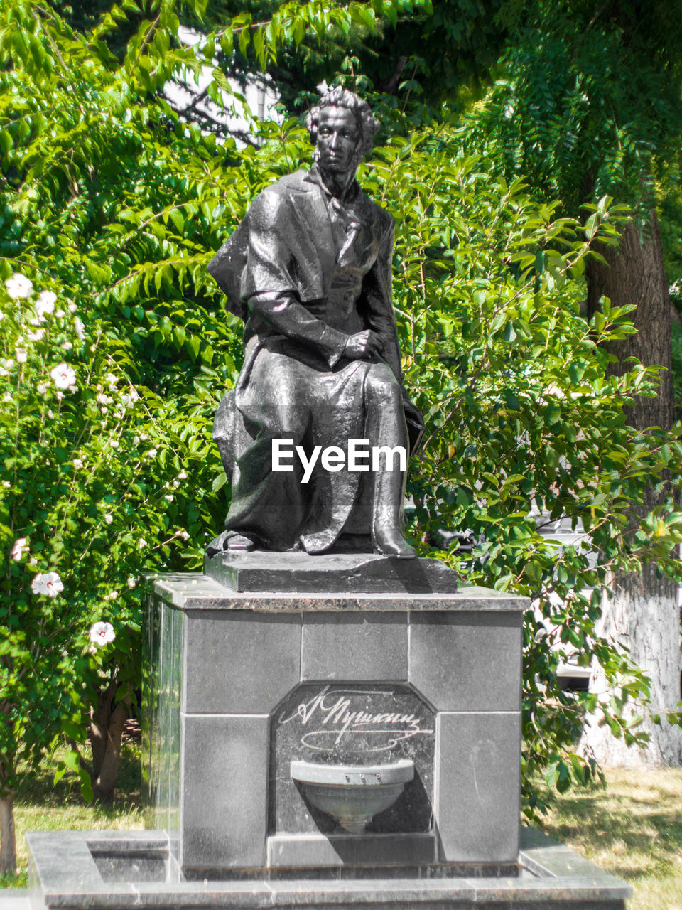 Statue against trees