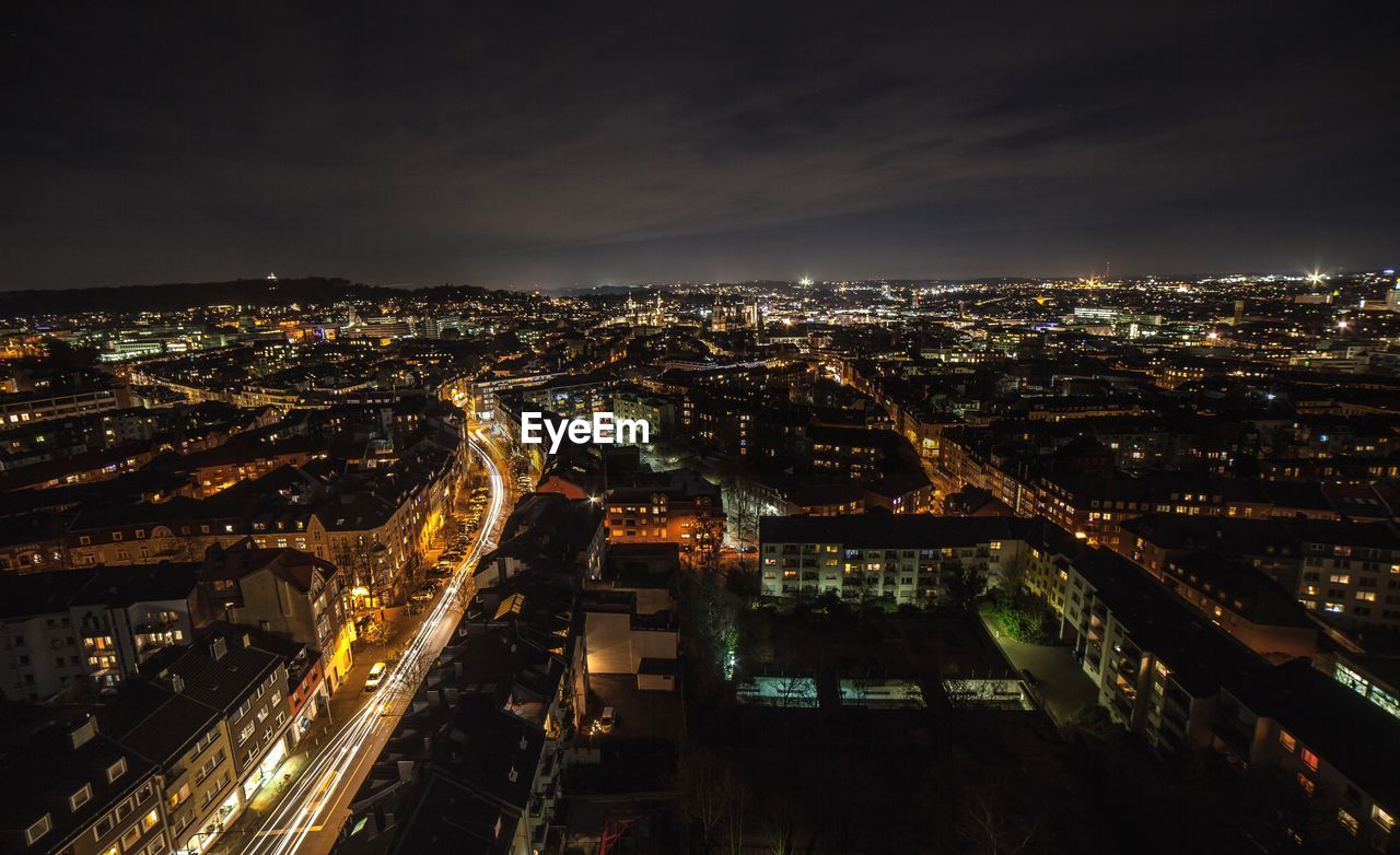 Aerial view of illuminated cityscape against sky at night