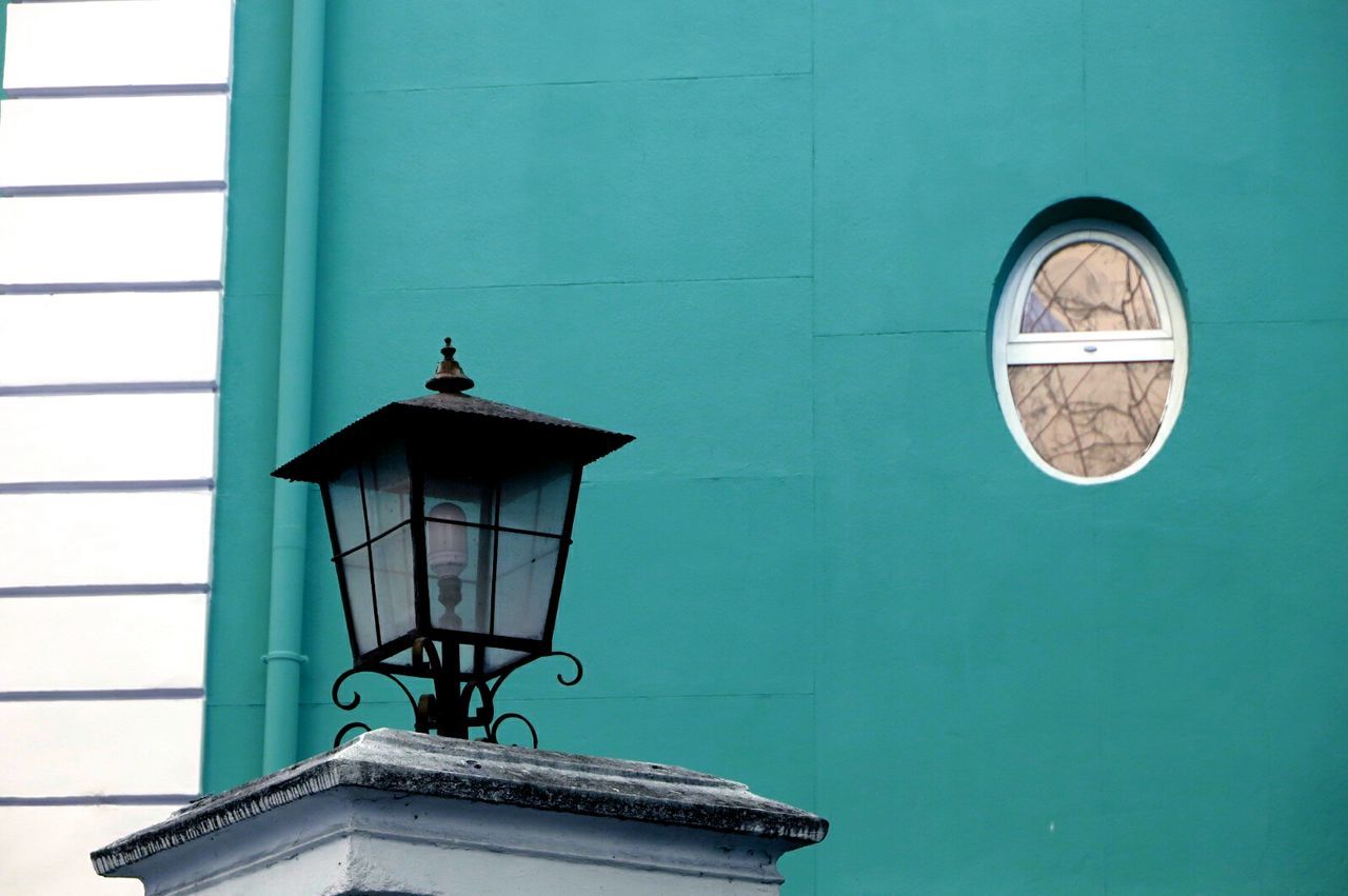 LOW ANGLE VIEW OF BIRD PERCHING ON HOUSE