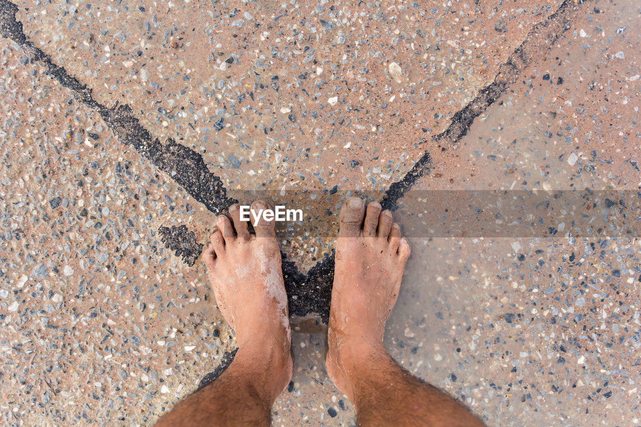 low section of woman on sand