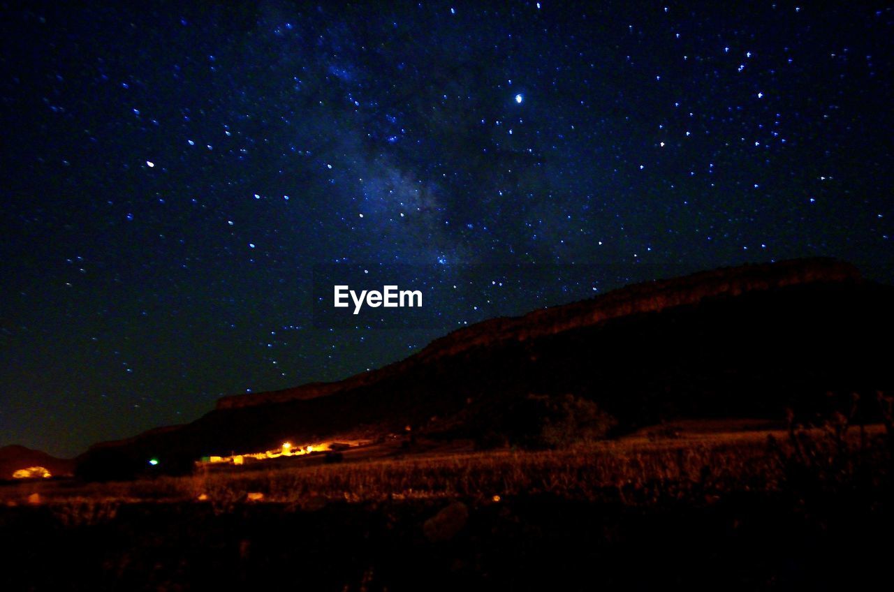 SCENIC VIEW OF MOUNTAIN AGAINST SKY AT NIGHT