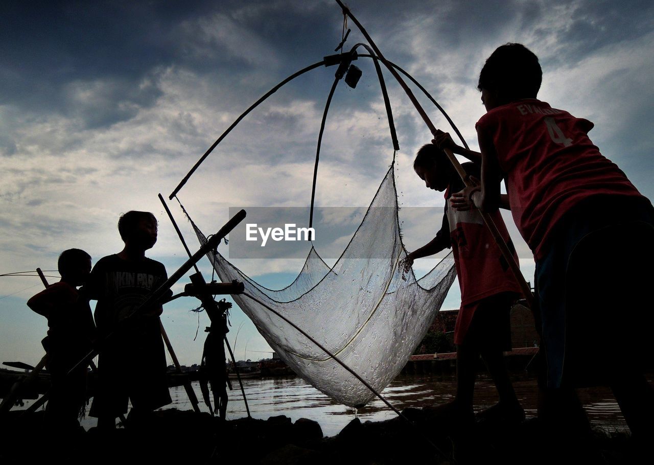 CHILDREN PLAYING WITH UMBRELLA