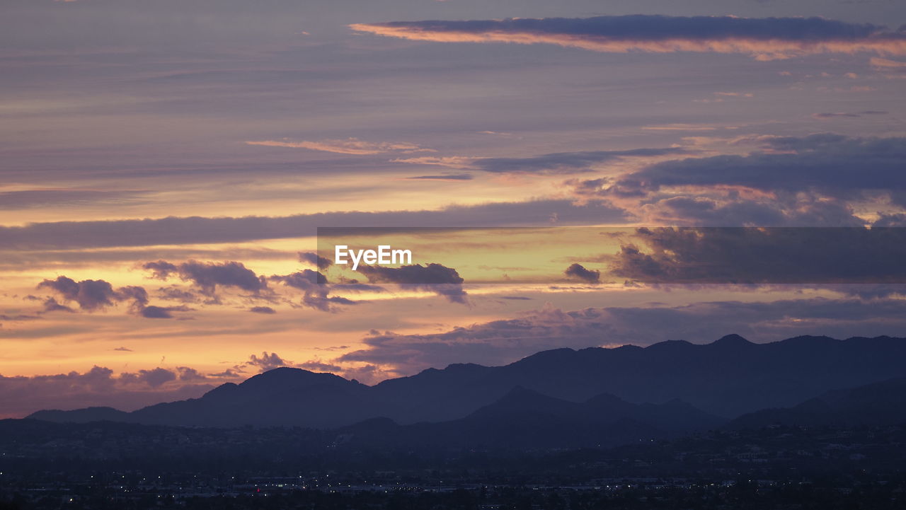 Scenic view of silhouette mountains against sky during sunset