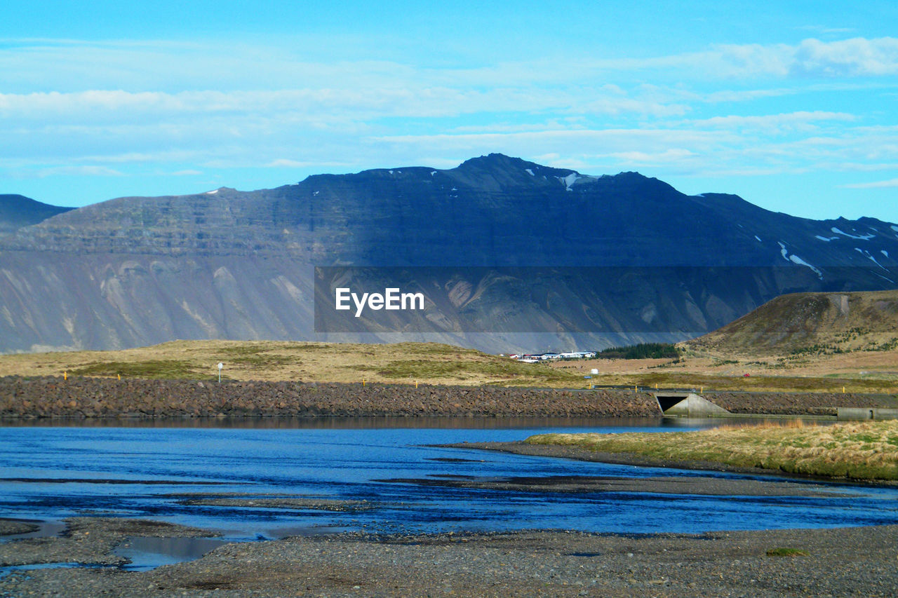 Scenic view of lake and mountains against sky