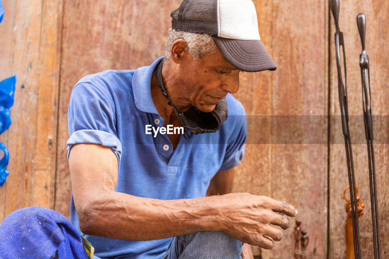 senior man looking away while standing outdoors