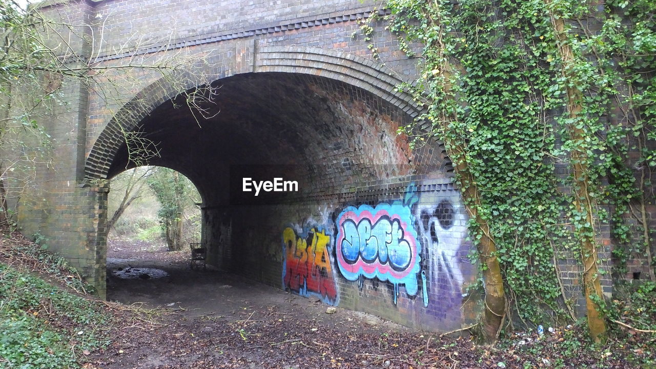 Graffiti on arch bridge wall