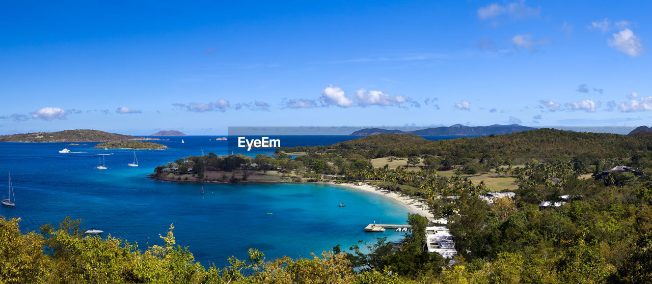 High angle view of sea and townscape against sky