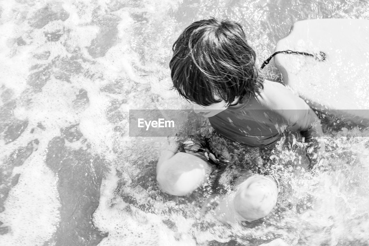 HIGH ANGLE VIEW OF GIRL PLAYING IN WATER