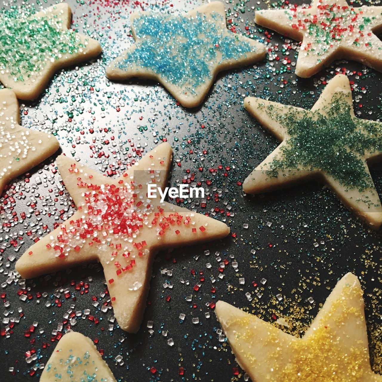 High angle view of sugar on star shaped cookies